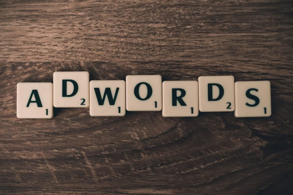 Crafting Captivating Headlines: Your awesome post title goes here Scrabble tiles spelling AdWords on a wooden surface, symbolizing digital marketing concepts.